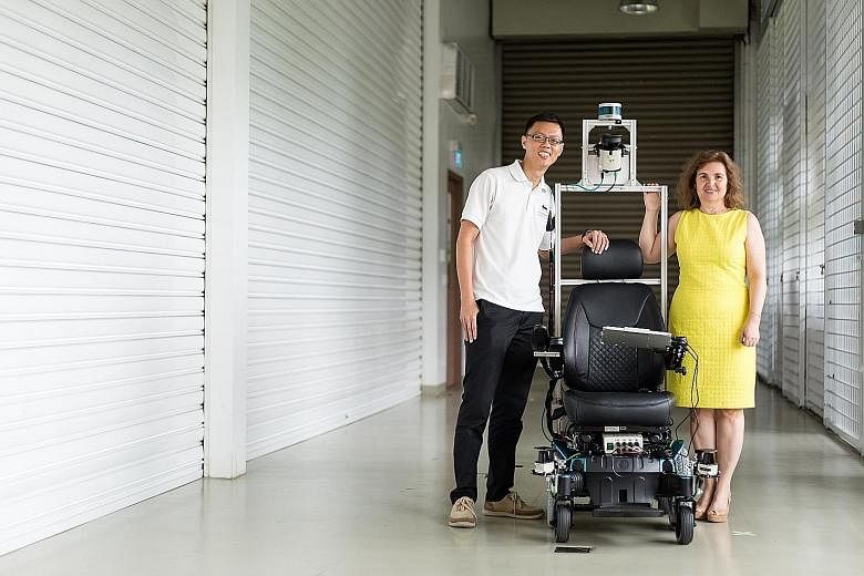 Dr Eng You Hong and Professor Daniela Rus from the Smart Future Urban Mobility team with the self-driving wheelchair that can manoeuvre through tight spaces autonomously. The Technical University of Munich Create is working with the Civil Aviation Au