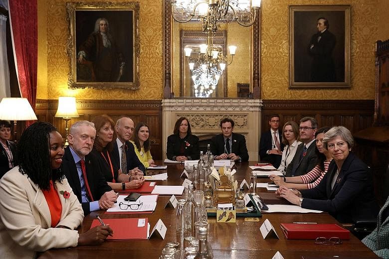The leader of Britain's Labour Party, Mr Jeremy Corbyn (second from left), at a meeting with Prime Minister Theresa May (far right) at Downing Street on Monday. Mrs May is facing calls to embark on a full-scale Cabinet reshuffle.