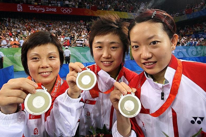 From left: Wang Yuegu, Feng Tianwei and Li Jiawei with their silver medals after losing 0-3 to China in the final of the Beijing Olympics in 2008. After a 48-year wait, Singapore was back on the podium.