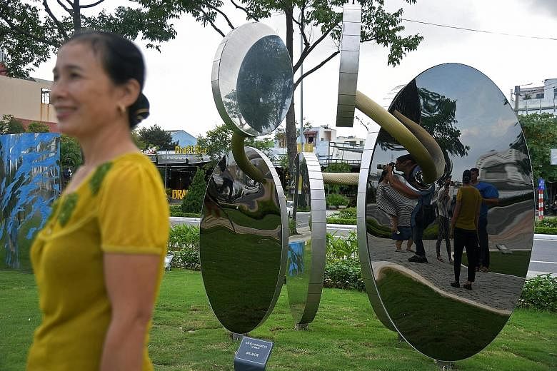 A sculpture by Singaporean artist Tan Wee Lit comprising six shiny metal discs is one of 20 artworks in the new Apec park in Danang, Vietnam. Tan's sculpture, titled Incon-Junction, is made with stainless steel and represents a solitary ring that run