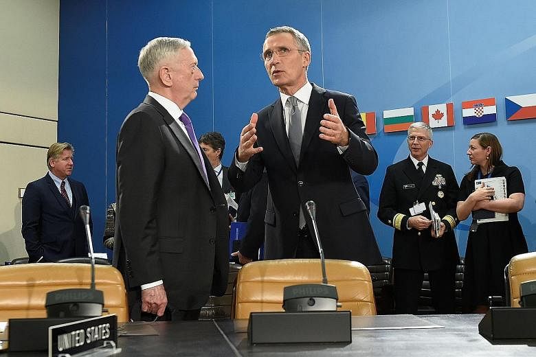 US Defence Minister James Mattis (at left) with Nato chief Jens Stoltenberg at the defence ministers' meeting in Brussels on Wednesday. The changes are part of Nato's biggest shake-up since the Cold War, with defence ministers backing the creation of