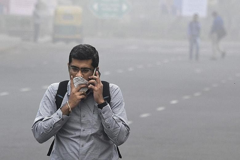 A man protecting himself from the smog in New Delhi on Wednesday.