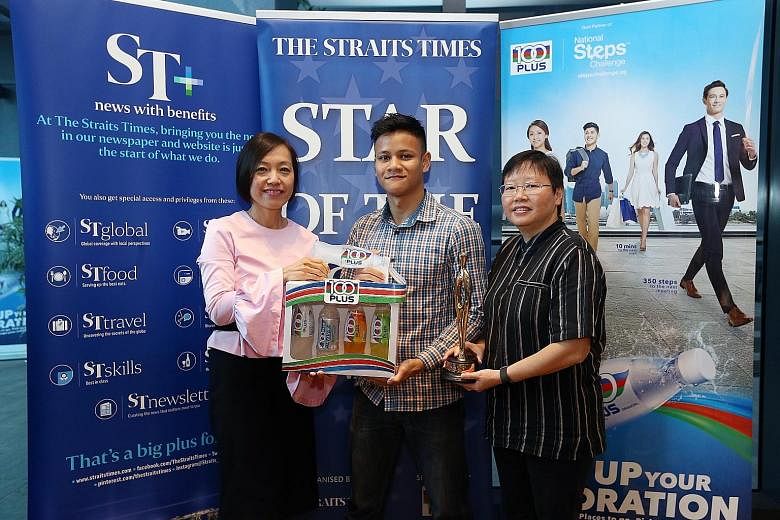Newly crowned IBO International super-featherweight champion Muhamad Ridhwan with Jennifer See (left), general manager of F&N Foods and The Straits Times sports editor Lee Yulin yesterday. The 29-year-old is looking forward to fighting in front of ho