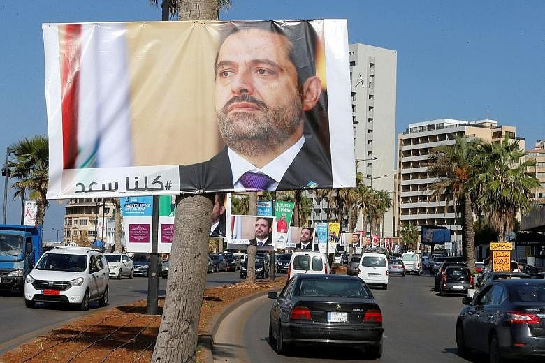 Posters of Mr Saad al-Hariri, who resigned as prime minister last Saturday, in Beirut, Lebanon, yesterday. Lebanon believes he is being detained in Saudi Arabia and its President has demanded his immediate return.
