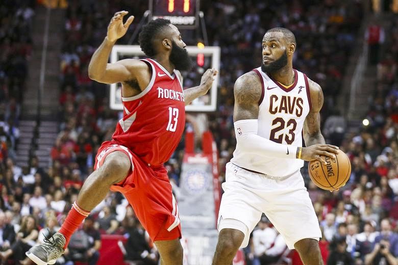 Cleveland Cavaliers forward LeBron James taking control of the ball as Houston Rockets guard James Harden defends during the fourth quarter on Thursday. The Rockets beat the Cavs 117-113 in the National Basketball Association game.