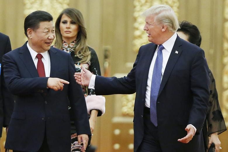 US President Donald Trump and Chinese President Xi Jinping arriving for a state dinner in Beijing on Thursday, together with US First Lady Melania Trump and Mr Xi's wife Peng Liyuan (partially hidden). Mr Trump and Mr Xi expressed willingness to work