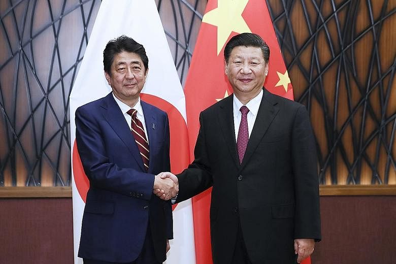Japanese Prime Minister Shinzo Abe meeting Chinese President Xi Jinping in Danang yesterday.