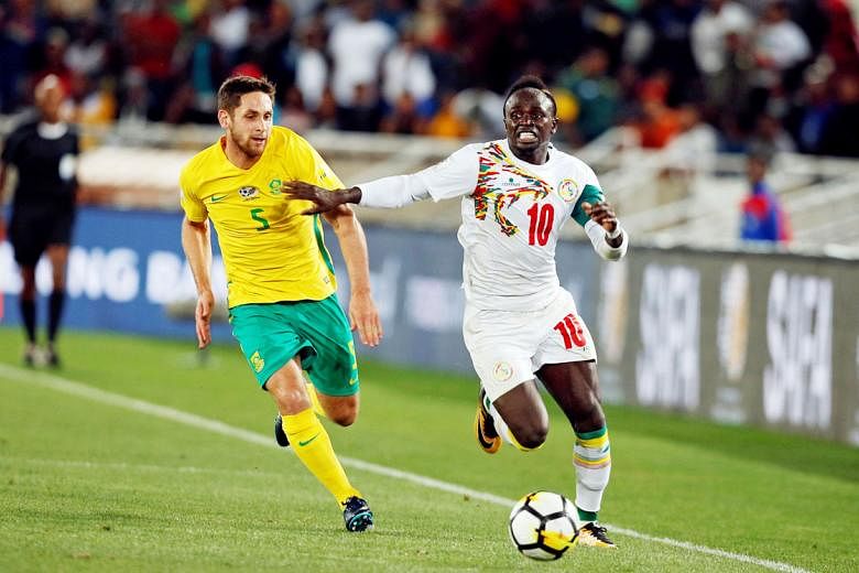 Senegal forward Sadio Mane outpacing South Africa midfielder Dean Furman on Friday. The Liverpool star was the difference as Senegal qualified for their second World Cup.