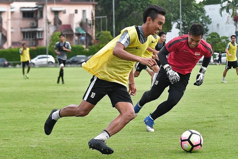 Faris Ramli (in yellow bib) enjoying national team training at the Geylang Field yesterday. The winger scored 11 goals for Home United in the S-League last season, but just once for the Lions this year.