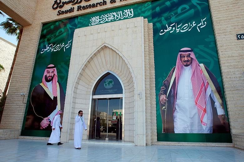 Posters of Saudi Arabia's King Salman (right) and Crown Prince Mohammed bin Salman in Riyadh. The recent arrests of top officials and businessmen is said to be an anti-graft purge, but some see it as a power grab by the Prince.