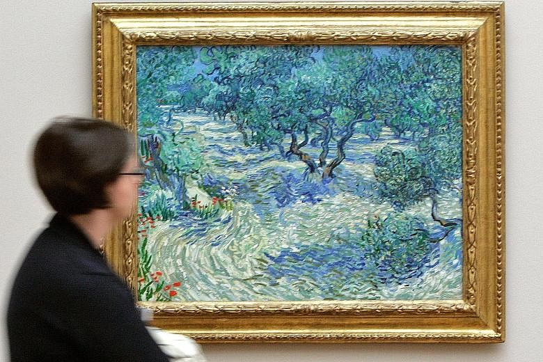 A dried grasshopper has been trapped in this painting, Olive Trees by Vincent van Gogh, for 128 years.