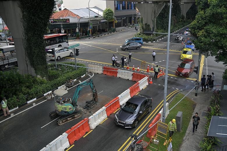 Repairs being carried out after a water pipe burst in Upper Serangoon Road last month. PUB manages a 5,500km pipe network and checks on all pipes at least once a year.