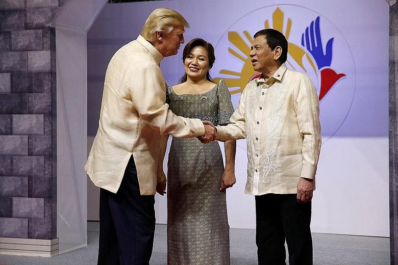 President Donald Trump being warmly received by President Rodrigo Duterte and his partner Cielito "Honeylet" Avancena at a gala dinner yesterday in Manila to mark Asean's 50th anniversary.