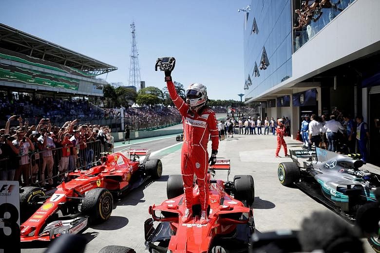Sebastian Vettel of Ferrari holding up his steering wheel in triumph after winning the Brazilian Grand Prix on Sunday, his fifth win this season. Threats made by Ferrari chairman Sergio Marchionne to leave the sport were the talk of the paddock in Br