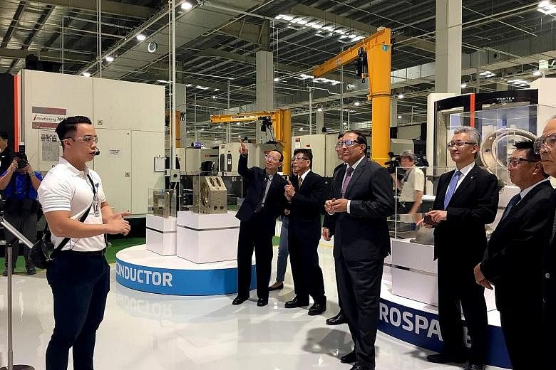 Minister for Trade and Industry (Industry) S. Iswaran touring JEP Precision Engineering's smart factory in Seletar Aerospace Park. The firm invested almost $35 million in the 200,000 sq ft plant, pumping money into technologies which include robotic 