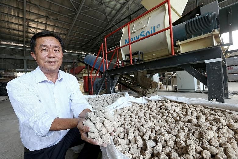 New Soil Technologies founder and managing director Phua Lam Soon with the new earth or New Soil that has been treated so it can be used for land reclamation.