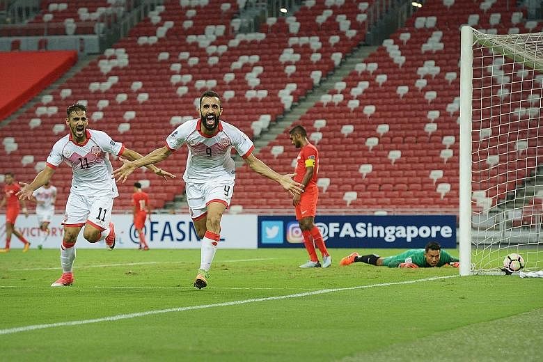 Striker Mahdi Abduljabbar (No. 9) celebrating scoring Bahrain's first goal as Singapore goalkeeper Hassan Sunny and skipper Hariss Harun look on helplessly. The Lions can no longer qualify for the 2019 Asian Cup.