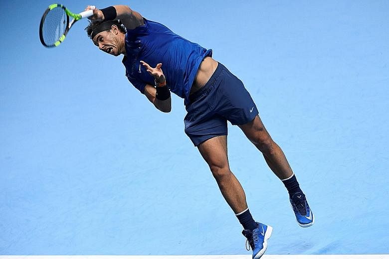 World No. 1 Rafael Nadal serving during his 7-6 (7-5), 6-7 (4-7), 6-4 ATP Finals defeat by seventh seed David Goffin. He withdrew after opening group stage match in London on Monday.