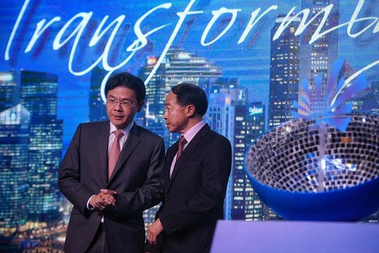 National Development Minister Lawrence Wong with Redas president Augustine Tan during the association's 58th anniversary dinner last night.