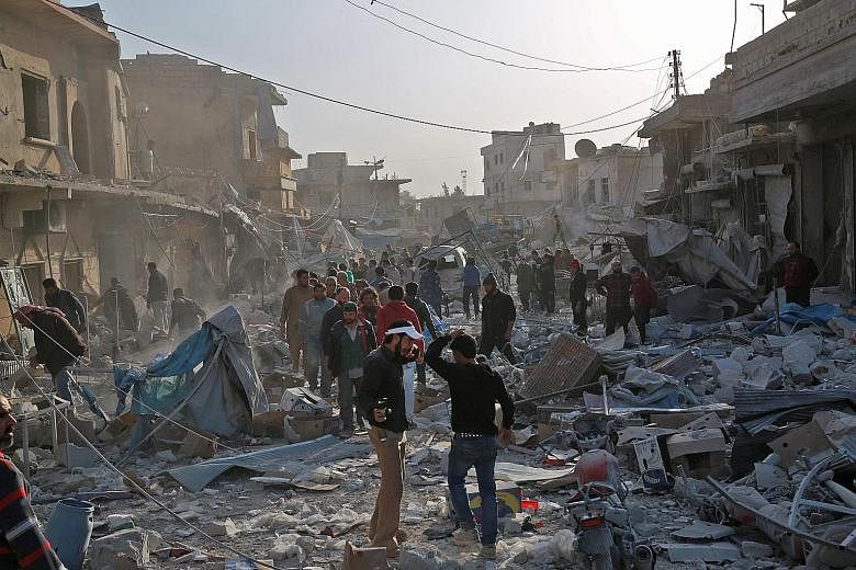 Syrians searching for survivors amid the debris following air strikes on the rebel-held town of Atareb in Syria's northern Aleppo province on Monday. At least 53 people, including children, were killed despite a "de-escalation zone" in place there, t