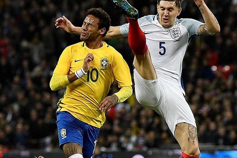 England's John Stones putting in a high but fair last-ditch challenge to deny Brazil's Neymar a clear run at goal. The Brazilian showed glimpses of his wizardry with the ball at Wembley, but ultimately could not break down a defence well-marshalled b