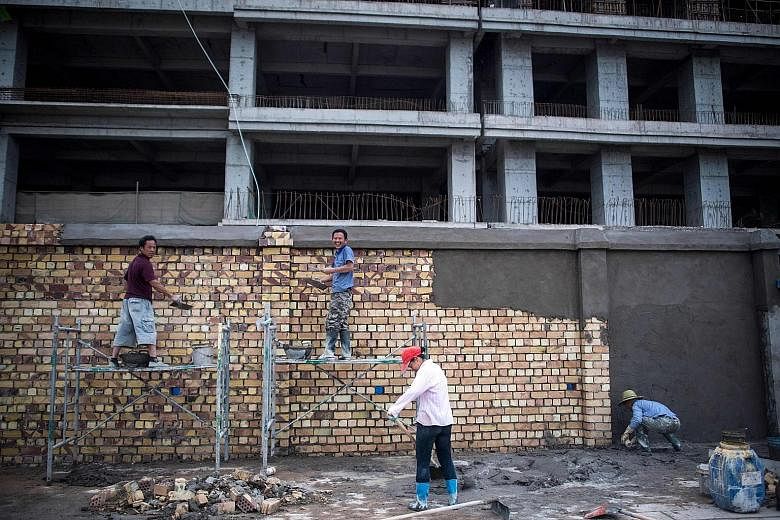 A construction site in China's western Xinjiang province. Developers were thrown a lifeline by regulators with the easing of access to offshore financing, but are braced for tough times ahead, as the nation reported the deepest slowdown in new home s
