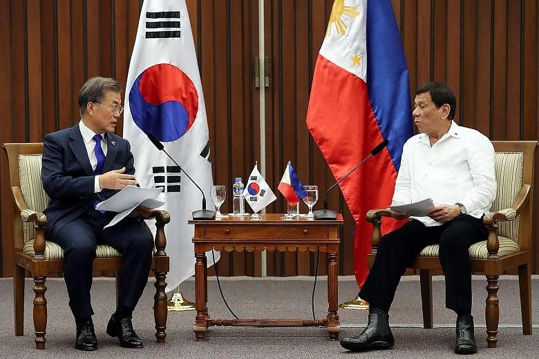 South Korean President Moon Jae In (far left) with Philippine President Rodrigo Duterte, when they met on the sidelines of the Asean summit in Manila on Monday.