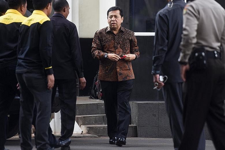 Above: Indonesian politician Setya Novanto arriving at the anti-graft agency KPK's building in Jakarta in July. Below: Police and investigators from KPK searched Mr Novanto's home on Wednesday.