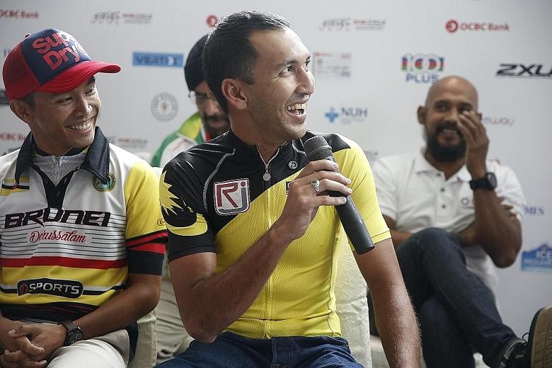 Malaysia team captain Muhammad Fauzan Ahmad Lutfi (front) talking up his team's chances in the OCBC Cycle Speedway South-east Asia Championship at yesterday's press conference at Hotel Jen Orchard Gateway. The two-time defending champions have a task