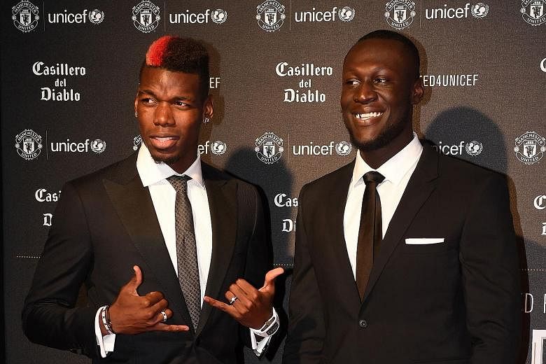 Paul Pogba attending a Unicef charity dinner on Wednesday. The midfielder will return to bolster the Manchester United squad today.