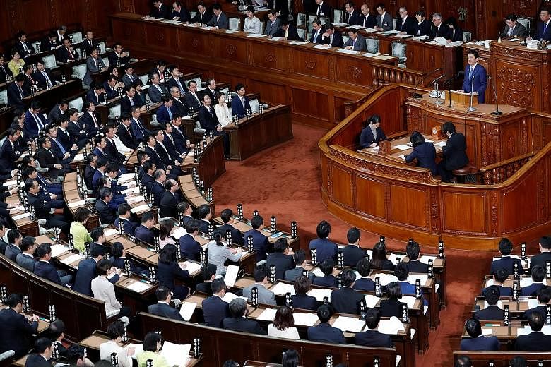 Prime Minister Shinzo Abe delivering his policy speech at the Lower House of Parliament in Tokyo yesterday. His Liberal Democratic Party and coalition partner have the support needed to move any revision to Japan's Charter.