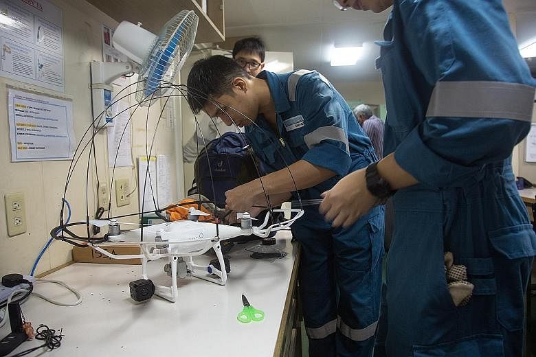 A drone being assembled (above). Using such machines for remote inspection, such as checking the internal structures in the cargo hold of a ship (left), can make the work of marine surveyors easier.