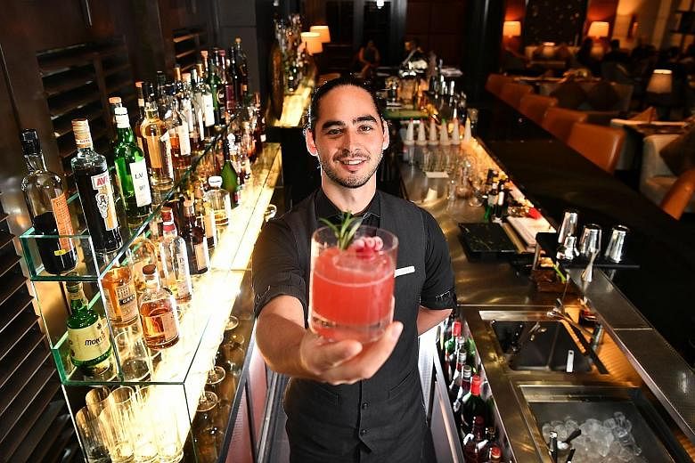 The Loco Group's beverage director Ajay Parag with a fruit mocktail. (Left) One-Ninety's head bartender Joseph Haywood with The Artist's Special cocktail. (Above) Catchfly's bartender Liam Baer making a low ABV cocktail.