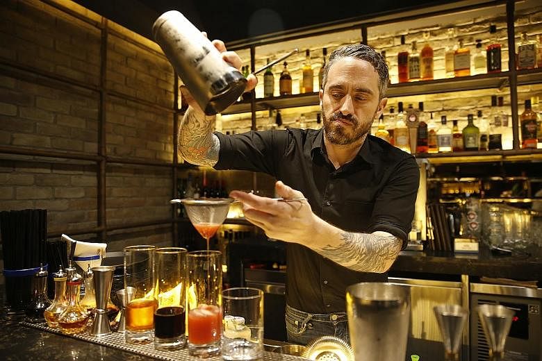 The Loco Group's beverage director Ajay Parag with a fruit mocktail. (Left) One-Ninety's head bartender Joseph Haywood with The Artist's Special cocktail. (Above) Catchfly's bartender Liam Baer making a low ABV cocktail.