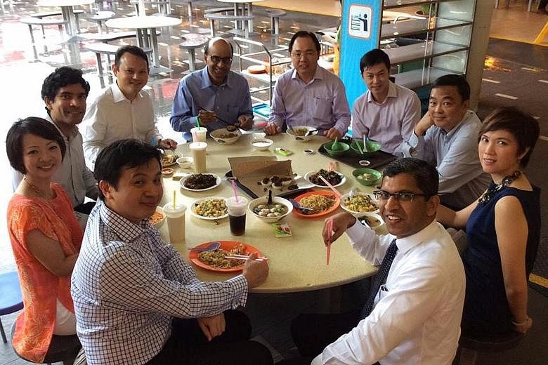 Having lunch with Deputy Prime Minister Tharman Shanmugaratnam, who was then also Finance Minister, and Mrs Josephine Teo (in blue), then Senior Minister of State for Finance, at Tiong Bahru food centre in 2014 were MPs (clockwise, from bottom left) 
