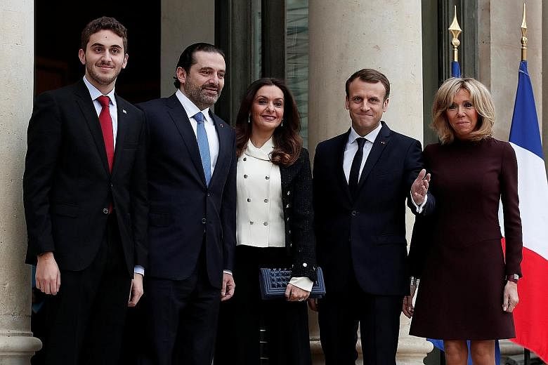 Lebanese Prime Minister Saad al-Hariri (second from left in picture), his wife Lara and their son Hussan with French President Emmanuel Macron and his wife Brigitte at the Elysee Palace in Paris yesterday. Mr Hariri accused Iran and its powerful Leba