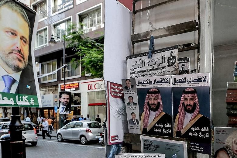 Posters supporting Mr Saad al-Hariri, who resigned as Lebanon's Prime Minister, seen with magazine covers featuring Saudi Arabia's Crown Prince Mohammed bin Salman in Beirut last week. Militia outfit Hizbollah's growing power may be a reason behind t