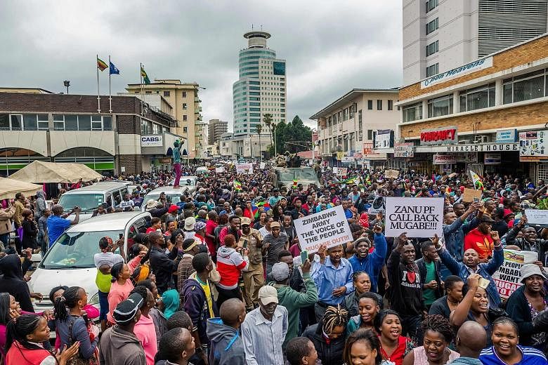 People on their way to a rally in the Harare township of Highfield yesterday. Many marched in the direction of Mr Mugabe's residence. Demonstrators rallying on the streets of Harare yesterday to demand President Robert Mugabe's resignation. He is the