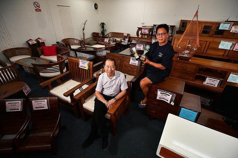 The Helping Hand liaison and training manager Vincent Tan (left) and Mr Tan Chin Nam, a former offender who underwent a rehabilitation programme there and now helps to run the halfway house. With Mr Tan is one of his pet songbirds, which helped him w