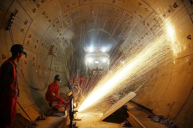Workers at the construction site of a subway line in Changzhou, Jiangsu province, last Friday. The National Development and Reform Commission wants to "raise the bar" for approving local rail projects amid growing concern over a debt-driven infrastru