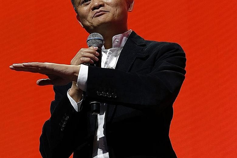 Alibaba founder Jack Ma (left) acknowledging fans after showing up with the main cast of his movie Gong Shou Dao during a gala event in Shanghai on Nov 11. The billionaire, seen here (right) speaking during his firm's inaugural Gateway '17 conference