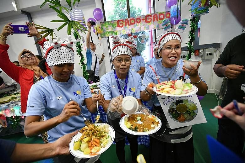 From left: Ms Masyitoh, 38, Mrs Rodiyah Pardi, 48, and Mrs Istiqomah, 44, members of the champion team from Indonesia, introducing their dish, gado-gado salad, to judges at the first International Food Fair yesterday.