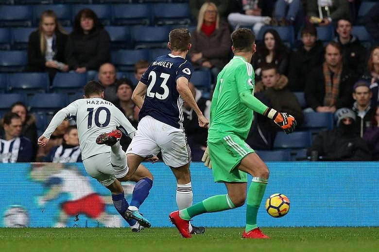 Chelsea forward Eden Hazard scoring his second against West Brom after rounding goalie Ben Foster. The English champions will now have to contend with a gruelling run of eight more games in a month.