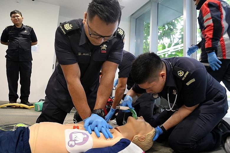 Singapore Civil Defence Force paramedics performing CPR at a media demonstration of new intervention techniques.