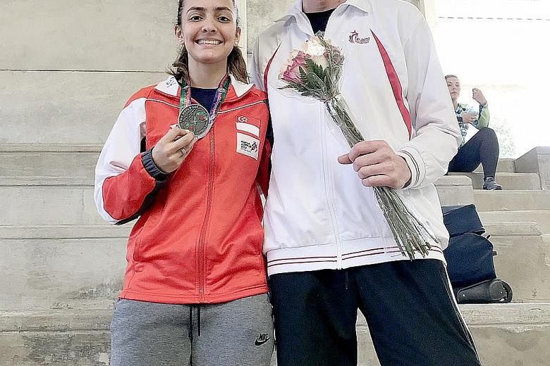 National fencer Amita Berthier with her coach Ralf Bissdorf at the Guatemala leg of the Junior World Cup. The 16-year-old clinched the Republic's first individual medal in the event with a silver and is set to move up to No. 12 in the junior world ra