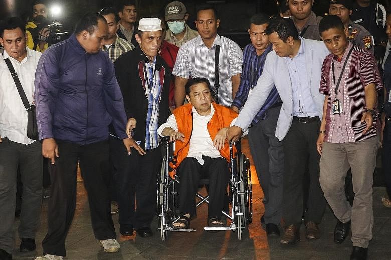 Mr Setya Novanto arriving in a wheelchair at the Corruption Eradication Commission building in Jakarta on Sunday, wearing the anti-graft agency's orange vest for detainees.