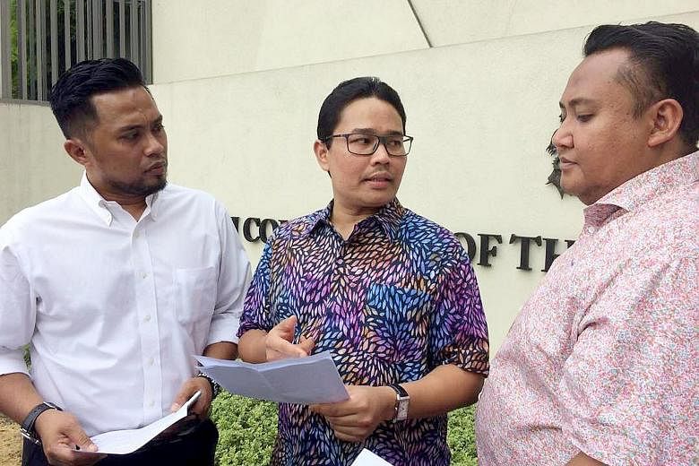 Umno Youth vice-chief Khairul Azwan Harun (centre) outside the Singapore High Commission yesterday with Umno Youth exco members.