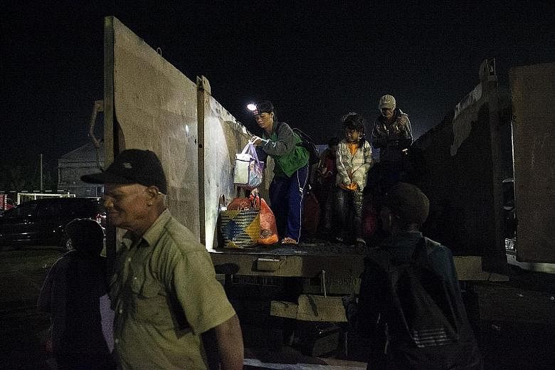 Evacuees arriving at an emergency shelter in Klungkung, Bali, yesterday. Mount Agung began erupting yesterday and it is reported that the height of the smoke has exceeded 700m from the peak of the mountain.