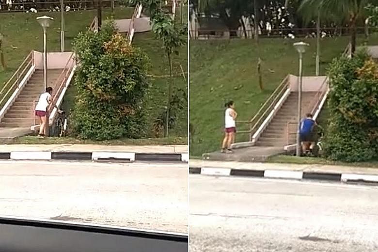The video shows a man and a woman wheeling a bicycle each into a drain. The incident is believed to have occurred on Sunday afternoon in Lower Delta Road.