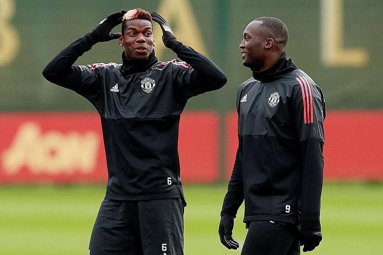 Manchester United's Romelu Lukaku and Paul Pogba (left) share a light moment in training ahead of their match against Basel. Pogba's return to the side has already reaped dividends for Jose Mourinho's men against Newcastle, and may yet edge them to t